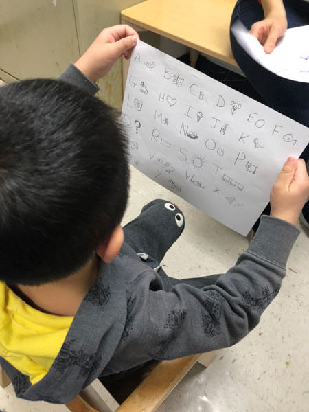 Child writing alphabet